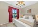 Cozy bedroom featuring a large window and ceiling fan at 40849 N Union Trl, Anthem, AZ 85086