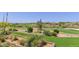 View of a lush golf course with desert landscape and mountain views at 40849 N Union Trl, Anthem, AZ 85086