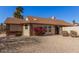 Front view of charming house with red flowers at 4130 E La Puente Ave, Phoenix, AZ 85044