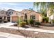 House exterior with a two-car garage, drought-tolerant landscaping, and walkway at 4205 E Bonanza Rd, Gilbert, AZ 85297