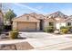 Tan house with a two-car garage and nicely landscaped front yard at 4205 E Bonanza Rd, Gilbert, AZ 85297