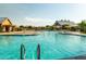 Large, inviting pool with lounge chairs and umbrellas at 4205 E Bonanza Rd, Gilbert, AZ 85297