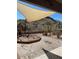 Desert landscape with patio, shade sail, and brick pavers at 4943 S Las Mananitas Trl, Gold Canyon, AZ 85118