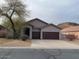 Charming single-story home featuring a two-car garage and desert landscaping at 4943 S Las Mananitas Trl, Gold Canyon, AZ 85118