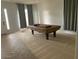 Spacious game room featuring a classic pool table with elegant detailing, tile and carpet flooring at 4943 S Las Mananitas Trl, Gold Canyon, AZ 85118