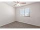 Bright bedroom with window and ceiling fan at 5234 W Odeum Ln, Phoenix, AZ 85043