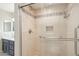 Bright bathroom featuring a walk-in shower with mosaic tile accents and accessible grab bars at 5998 N 78Th St # 116, Scottsdale, AZ 85250