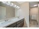 Bathroom with double vanity, marble countertop, and shower at 5998 N 78Th St # 116, Scottsdale, AZ 85250