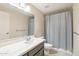 Clean bathroom featuring a modern vanity with marble countertop and shower with patterned curtain at 5998 N 78Th St # 116, Scottsdale, AZ 85250
