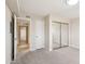 Bedroom featuring neutral carpet, mirrored closet doors, and access to hallway at 5998 N 78Th St # 116, Scottsdale, AZ 85250