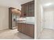 Modern kitchen features stainless steel appliances, granite countertops, wood cabinets and tile floors at 5998 N 78Th St # 116, Scottsdale, AZ 85250