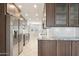 Modern kitchen featuring stainless steel appliances, granite countertops, wood cabinets and tile flooring at 5998 N 78Th St # 116, Scottsdale, AZ 85250