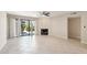 Open living room with tile flooring, a ceiling fan, fireplace, and sliding glass doors to a patio at 5998 N 78Th St # 116, Scottsdale, AZ 85250