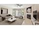 Cozy living room with a fireplace, plush seating, decorative artwork and sliding doors leading to the outdoors at 5998 N 78Th St # 116, Scottsdale, AZ 85250