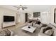 Comfortable living room with plush seating, a modern entertainment center, and an open view to the kitchen at 5998 N 78Th St # 116, Scottsdale, AZ 85250