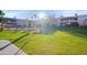 Community pool and spa with surrounding lawn area at 5998 N 78Th St # 116, Scottsdale, AZ 85250