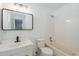 Clean bathroom with white vanity, tub, and tile shower at 7519 N 23Rd Ave, Phoenix, AZ 85021