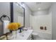 Bright bathroom with a shower-tub combo and a modern single sink vanity at 7519 N 23Rd Ave, Phoenix, AZ 85021