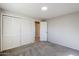 Spacious bedroom with mirrored closet doors and carpet at 7519 N 23Rd Ave, Phoenix, AZ 85021