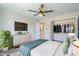 Bright bedroom featuring a ceiling fan, TV, closet, and ensuite bathroom at 7519 N 23Rd Ave, Phoenix, AZ 85021