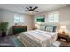 Bright bedroom with neutral colors, stylish furnishings, ceiling fan, and natural light at 7519 N 23Rd Ave, Phoenix, AZ 85021