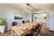 Dining room featuring hardwood floors, modern light fixture, dining table, and view into adjacent kitchen at 7519 N 23Rd Ave, Phoenix, AZ 85021