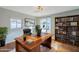 Well-lit home office with a large desk, built-in bookshelves, and natural light at 7519 N 23Rd Ave, Phoenix, AZ 85021