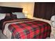 Bedroom with a double bed and plaid blanket at 7807 E Main St # Cc-70, Mesa, AZ 85207