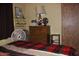 Cozy bedroom with plaid bedspread and dresser at 7807 E Main St # Cc-70, Mesa, AZ 85207
