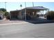 Mobile home with carport, golf cart, and desert landscaping at 7807 E Main St # Cc-70, Mesa, AZ 85207