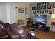 Living room with leather recliners, large TV and wood flooring at 7807 E Main St # Cc-70, Mesa, AZ 85207