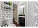 Modern bathroom with geometric patterned wallpaper and updated vanity at 8700 E University Dr # 253, Mesa, AZ 85207