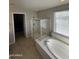 Spa-like bathroom with soaking tub, shower, and tile floors at 14727 W Pasadena Ave, Litchfield Park, AZ 85340