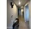 Long hallway with tile flooring and a marble console table at 14727 W Pasadena Ave, Litchfield Park, AZ 85340