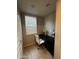 Small home office with desk, chair, and window with blinds at 14727 W Pasadena Ave, Litchfield Park, AZ 85340