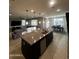 Open concept kitchen with island and breakfast bar at 14727 W Pasadena Ave, Litchfield Park, AZ 85340