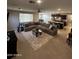 Spacious living room with large sectional sofa and open floor plan at 14727 W Pasadena Ave, Litchfield Park, AZ 85340