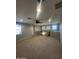 Spacious loft area with neutral carpeting and a ceiling fan at 14727 W Pasadena Ave, Litchfield Park, AZ 85340