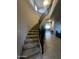 Impressive curved staircase with ornate railing and carpet runner at 14727 W Pasadena Ave, Litchfield Park, AZ 85340
