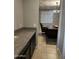 Wet bar with granite countertop and dark cabinetry at 14727 W Pasadena Ave, Litchfield Park, AZ 85340