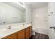 Bright bathroom featuring a double vanity and a shower-tub combo at 18409 W Dawn Dr, Surprise, AZ 85374