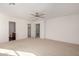 Spacious bedroom with a ceiling fan and several doorways at 18409 W Dawn Dr, Surprise, AZ 85374