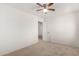 This bedroom has neutral carpeting and a simple light fixture at 18409 W Dawn Dr, Surprise, AZ 85374