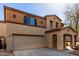 Inviting two-story home features a covered porch and attached two-car garage at 18409 W Dawn Dr, Surprise, AZ 85374