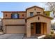 Inviting two-story home features a covered porch and attached two-car garage at 18409 W Dawn Dr, Surprise, AZ 85374