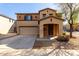 Inviting two-story home features a covered porch and attached two-car garage at 18409 W Dawn Dr, Surprise, AZ 85374