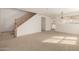Bright living area features neutral carpet, staircase, and flows seamlessly into other spaces at 18409 W Dawn Dr, Surprise, AZ 85374