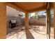 Outdoor patio with BBQ, landscaped with desert rock and pavers and covered patio area at 18409 W Dawn Dr, Surprise, AZ 85374