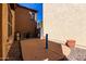 View of concrete patio area with desert landscaping between the home and block fence at 18409 W Dawn Dr, Surprise, AZ 85374