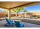 Relaxing backyard patio with two blue chairs and gravel landscaping at 1873 W Dion Dr, Anthem, AZ 85086